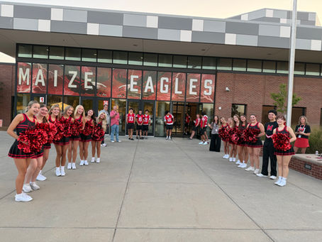 Football and Cheer Unite to Welcome Students Back on Their First Day